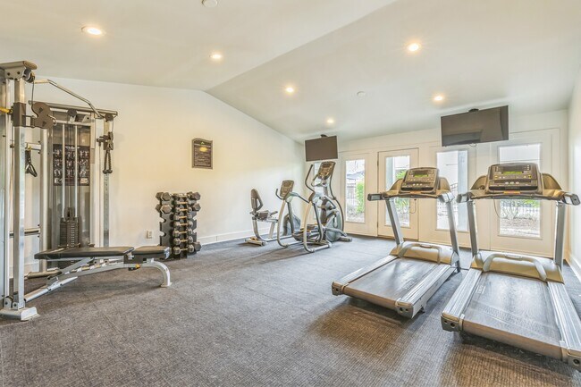 Stay active in our spacious fitness center featuring treadmills, free weights, and complete exercise equipment, professionally operated by Highlands Vista Group. - Ashford Place