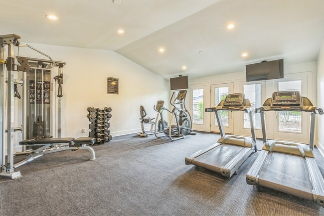 Stay active in our spacious fitness center featuring treadmills, free weights, and complete exercise equipment, professionally operated by Highlands Vista Group. - Ashford Place