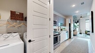 Located in Houston's vibrant Midtown neighborhood, this one-bedroom, one-bathroom residence offers a thoughtfully designed layout with a distinct urban-modern aesthetic. The living and sleeping areas are housed in a generously sized primary bedroom that impresses with soaring ceilings accented by exposed structural beams and industrial-style ductwork, lending the space a loft-like character. A ceiling fan overhead and large floor-to-ceiling windows flood the room with natural light while framing sweeping views of the Houston skyline, creating a bright and airy ambiance throughout.

The galley-style kitchen is sleek and highly functional, featuring stainless steel appliances including a gas range, built-in microwave, dishwasher, and refrigerator. White lower cabinetry is paired with warm wood-toned upper cabinets, a classic subway tile backsplash with under-cabinet LED lighting, and a matte black faucet over a single-basin sink, delivering a clean, contemporary look.

The bathroom offers a relaxing tub-shower combination enclosed by marble-look porcelain tile surround and finished with matte black fixtures, complementing the home's cohesive modern design language. Light wood-look flooring runs throughout, tying each space together seamlessly. A dedicated closet and in-unit laundry add practical convenience to this well-curated urban residence.