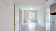 Located at 2424 Tulane Ave #729 in New Orleans, LA, this modern single-floor unit offers 790 square feet of thoughtfully designed living space across 4 bedrooms and 2 bathrooms. The contemporary interior is defined by clean lines, neutral tones, and polished concrete floors throughout. The kitchen is a standout feature, equipped with stainless steel appliances including a refrigerator, electric range, built-in microwave, and dishwasher. Two-tone cabinetry pairs white upper cabinets with warm wood-finish lower cabinets, complemented by a white subway tile backsplash and light quartz countertops. Both bathrooms mirror each other in design, featuring large-format marble-look tile surrounding the tub-shower combos, wood-accented vanities with white countertops, and recessed lighting. The primary bedroom measures 130 square feet and, like the other bedrooms, includes a ceiling fan, natural light from exterior-facing windows, and neutral wall finishes. A dedicated closet adds practical storage. The unit's clean, minimalist aesthetic is consistent throughout, creating a bright and cohesive living environment well-suited for modern urban living in New Orleans.