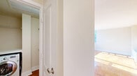 Located at 1845 Summit Pl NW in Washington, DC's vibrant 20009 corridor, this efficiently designed single-floor unit makes smart use of its compact footprint. The open-concept living area is anchored by warm parquet wood flooring that catches abundant natural light streaming through a large picture window, offering pleasant views of the surrounding neighborhood's tree-lined streets and classic brick architecture.

The kitchen is a standout feature, equipped with rich cherry wood cabinetry extending to the ceiling for ample storage, granite countertops, and a full suite of stainless steel appliances including a gas range, built-in microwave, and refrigerator. A peninsula with a single-basin sink and additional counter space makes the kitchen both functional and well-suited for everyday cooking. Light-toned tile flooring completes the space.

The living area is bright and open, with clean white walls and the same attractive parquet flooring that flows throughout. The bathroom is neatly appointed with a full soaking tub and shower combination, a white tile surround, and dark-toned overhead cabinetry providing additional storage. A dedicated closet rounds out the unit's practical offerings. The overall ambiance is clean, light-filled, and well-maintained, offering a functional urban living experience in a prime Washington, DC location.