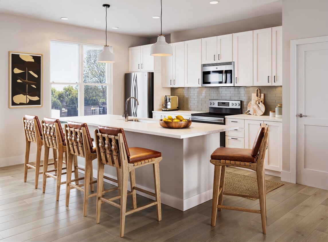 Townhome kitchen with white cabinetry, tile backsplash, stainless steel appliances, pendant lighting, and hard-surface vinyl plank flooring (Rendering) - Avalon Lake Norman