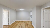 Located at 7933 Old Sylacauga Hwy in Childersburg, Alabama, this 2-bedroom, 2-bathroom unit offers a clean, modern aesthetic across a practical single-floor layout. Light wood-style flooring flows consistently throughout the space, complementing the neutral gray wall tones and bright white trim found in every room.

The kitchen features white shaker-style cabinetry, granite-look countertops, a stainless steel sink, a dishwasher, and a stainless steel refrigerator — all thoughtfully arranged in a galley configuration that maximizes efficiency.

Both bedrooms are comfortably sized, with the primary bedroom offering a generous footprint. Each room is equipped with a ceiling fan with light fixture and windows fitted with blinds that allow for natural light and outdoor views. The primary bedroom includes direct access to one of the two bathrooms, which is outfitted with a full tub/shower combination, toilet, and vanity. The second bedroom features closet access and is serviced by the additional full bathroom, which mirrors the same clean, white finishes including a tub/shower unit and wood-style flooring.

The overall ambiance is bright and move-in ready, with a cohesive design language that prioritizes functionality and simplicity throughout.