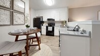 Located at 161 Lansing Cir in Mooresville, NC, this single-floor home offers three bedrooms and two bathrooms across a efficiently designed layout. The kitchen is a standout feature, showcasing white cabinetry, light wood-look flooring, stone-look countertops, and black appliances including a refrigerator and electric range. A dining area sits adjacent to the kitchen, creating a natural flow for everyday living. The primary bedroom is a comfortable retreat, featuring ceiling fan, carpeted flooring, and a walk-in closet with built-in shelving. The additional two bedrooms are equally well-appointed, each offering ceiling fans, carpeted floors, natural light from windows with blinds, and closet storage. Both bathrooms are finished with white vanity cabinetry, granite-look countertops, framed mirrors, and brushed nickel fixtures, lending a clean and polished aesthetic. Neutral gray tones carry throughout the home, creating a cohesive and calming atmosphere. The single-story layout ensures convenient, accessible living, making this Mooresville residence a practical and comfortable option.