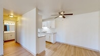 Located at 2415 Springdale Rd in Waukesha, WI, this one-bedroom, two-bathroom unit offers a well-organized, single-floor layout designed for comfortable everyday living. The open living room is bathed in natural light from a large sliding glass door that offers outdoor views and provides easy access to the exterior. Light wood-style flooring runs throughout the main living areas, complemented by baseboard heating and a wall-mounted air conditioning unit. A ceiling fan with an integrated light fixture adds functionality to the space. The galley-style kitchen is efficiently designed with white cabinetry, marble-patterned countertops lining both sides, white appliances including a range and refrigerator, and a dedicated pantry for additional storage. A half-wall with a breakfast bar connects the kitchen to the main living area. The bedroom features plush carpeting, a bright window with outdoor views, and a full-panel double closet offering generous storage. Both bathrooms are clean and functional — one featuring a full soaking tub with built-in shelving, and the other showcasing a marble-topped vanity with white cabinetry and wood-style flooring. A separate entry area with a classic wood-toned door and adjacent closet completes the layout.