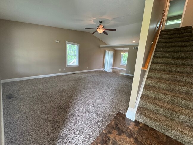 View of living room and steps leading to 2nd floor as you enter the front door. - 1343 Easy St