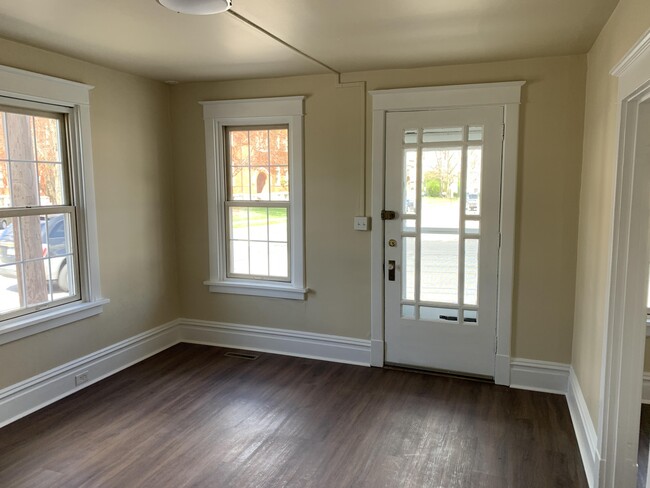 Front door leading into living room, to the left is the eat-in kitchen, stairs to the second floor - 200 S High St