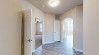 This single-story residence at 1801 Champlin Dr in Little Rock, Arkansas offers a well-designed layout that balances comfort and functionality. The entry hall features wood-look flooring and an arched passageway that leads into the main living areas, setting a welcoming tone throughout.

The spacious living room is a standout feature, highlighted by a tile-surround fireplace, crown molding, a ceiling fan, and multiple windows that fill the room with natural light. A door provides direct exterior access, enhancing the open feel of the space.

The kitchen is outfitted with white cabinetry, a white subway tile backsplash, granite countertops, and stainless steel appliances including a refrigerator, range, and microwave. A peninsula counter connects seamlessly to the living and dining area, making it ideal for everyday use.

The bedrooms are carpeted and generously proportioned, each equipped with ceiling fans and ample closet space, including walk-in options. The bathrooms continue the refined aesthetic with granite-topped vanities, wood-look tile flooring, and tub-shower combinations with tiled surrounds.

Throughout the home, neutral tones, textured ceilings, and consistent finishes create a cohesive and inviting atmosphere.