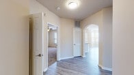 This single-story residence at 1801 Champlin Dr in Little Rock, Arkansas offers a well-designed layout that balances comfort and functionality. The entry hall features wood-look flooring and an arched passageway that leads into the main living areas, setting a welcoming tone throughout.

The spacious living room is a standout feature, highlighted by a tile-surround fireplace, crown molding, a ceiling fan, and multiple windows that fill the room with natural light. A door provides direct exterior access, enhancing the open feel of the space.

The kitchen is outfitted with white cabinetry, a white subway tile backsplash, granite countertops, and stainless steel appliances including a refrigerator, range, and microwave. A peninsula counter connects seamlessly to the living and dining area, making it ideal for everyday use.

The bedrooms are carpeted and generously proportioned, each equipped with ceiling fans and ample closet space, including walk-in options. The bathrooms continue the refined aesthetic with granite-topped vanities, wood-look tile flooring, and tub-shower combinations with tiled surrounds.

Throughout the home, neutral tones, textured ceilings, and consistent finishes create a cohesive and inviting atmosphere.