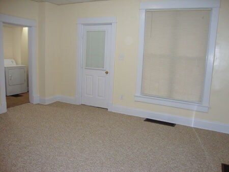 Living room looking at front door. Laundry room on left. - 522 E Market St