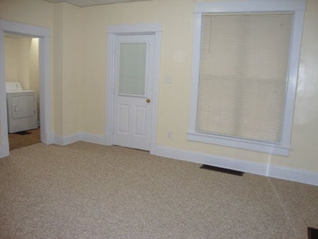 Living room looking at front door. Laundry room on left. - 522 E Market St