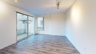 Located at 1400 S Figueroa St in the heart of downtown Los Angeles, this modern single-floor residence offers a well-designed layout with contemporary finishes throughout. Wood-look plank flooring flows seamlessly across the living areas and bedrooms, providing a warm, cohesive aesthetic.

The open living area is filled with natural light from large floor-to-ceiling windows and sliding glass doors that lead to an outdoor balcony, offering views of the surrounding cityscape and neighboring amenity areas. A sculptural gold light fixture adds an eye-catching accent to the space.

The kitchen is outfitted with dark wood cabinetry, white quartz countertops, stainless steel appliances including a gas range, microwave, and dishwasher, complemented by a mosaic tile backsplash that introduces a refined design element.

The bedrooms feature clean white walls, ample natural light, and built-in closets with sliding doors and double hanging rods for generous storage. One bedroom benefits from direct outdoor views, enhancing its bright and airy feel.

The bathrooms are finished with large-format tile flooring, white subway tile shower surrounds, dark wood vanity cabinetry, white quartz countertops, and backlit vanity mirrors, lending a sleek, modern character to these functional spaces.