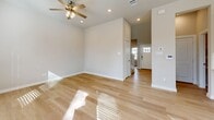 Located at 2205 Kincaid Lane in Melissa, TX, this two-story home offers a thoughtfully designed layout spread across two floors. The main level features an open-concept kitchen and living room, where light hardwood floors and recessed lighting create a bright, welcoming atmosphere. The kitchen is well-appointed with white shaker cabinets, a classic subway tile backsplash, stainless steel appliances including a French door refrigerator and electric range, and a double-basin sink with light countertops. A convenient half bathroom is also found on the main floor, alongside a staircase with a sleek dark handrail leading to the upper level and direct access to the attached two-car garage. Upstairs, three bedrooms offer natural light through multiple windows, with vaulted or angled ceilings adding architectural interest. The generously sized primary bedroom includes a dedicated closet and access to a private bathroom featuring marble-style tile flooring. Additional closets and hallways connect the upper-level spaces efficiently. With four bathrooms total, including a marble-tiled full bath upstairs, the home balances comfort and functionality. Neutral warm-beige tones and consistent light wood flooring throughout give the home a cohesive, modern aesthetic.