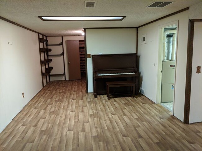 Basement open area with piano - 28 James Circle