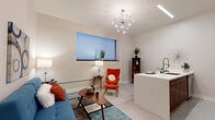 This single-floor unit showcases a cohesive mid-century modern design throughout its well-organized layout. The open-concept living area flows naturally into the kitchen, creating a spacious and functional common space. The living room features neutral carpet flooring, tall walls painted in a soft warm tone, and a statement sputnik chandelier overhead, complemented by a window fitted with modern cellular shades that allow for controlled natural light.

The kitchen is outfitted with rich walnut-toned cabinetry, stainless steel appliances including a refrigerator, range, and microwave, and a teal mosaic tile backsplash that adds a vibrant accent. A white peninsula with an integrated sink provides additional prep space and casual dining.

Two bedrooms offer comfortable retreats, each with plush carpet flooring and ample closet space. The bathroom is notably well-appointed, featuring a walk-in shower tiled in deep teal subway tile, a floating walnut vanity with a white countertop, and a warm wood-framed mirror.

A dedicated laundry closet houses a full-size front-loading washer and dryer alongside the water heater and HVAC unit, maximizing the practicality of the space. The overall ambiance is modern, clean, and thoughtfully designed.