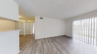 Located at 741 Providence Trace Cir in Brandon, Florida, this single-floor unit offers a clean, functional layout with a bright and neutral aesthetic throughout. The open living area is finished with durable wood-look plank flooring and features a sliding glass door that invites natural light, creating an airy and welcoming atmosphere. A textured ceiling adds character to the living space.

The galley-style kitchen is efficiently designed with white cabinetry, white countertops, and a full suite of appliances including a refrigerator and stovetop. A pass-through peninsula connects the kitchen to the living and dining areas, enhancing the sense of openness and flow between spaces.

The bedrooms are carpeted for comfort and each includes a ceiling fan for added climate control. Large windows dressed with vertical blinds allow for generous natural light and outdoor views. Closet space is provided in the bedrooms, with louvered bifold doors adding a classic touch.

Two full bathrooms serve the unit, each featuring wood-look tile flooring, a tub and shower combination with white tile surround, a single-sink vanity with cabinet storage, and a large mirror with overhead lighting. The consistent use of white and light tones throughout gives the entire space a clean, move-in-ready feel.