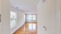 Located at 1 Rosewood Ave in Springfield, NJ, this two-story, two-bedroom, three-bathroom home offers a well-designed layout spread across two floors. The main level features a bright, open living room with gleaming hardwood floors and multiple windows that invite abundant natural light. The kitchen is equipped with warm wooden cabinetry, dark granite countertops, stainless steel appliances including a gas range, microwave, and sink, and flows seamlessly into the living area via tile flooring. A hallway connects the main living spaces to a staircase leading to the upper level. Upstairs, the spacious primary bedroom offers generous proportions and a dedicated closet with wire shelving for organized storage. The second bedroom features grey-toned hardwood flooring and closet access. Both upper-floor bedrooms are bright and well-proportioned. The three bathrooms are cleanly finished — one features a pedestal sink, tile surround, and oval mirror, while another includes a vanity with granite countertop and a shower-tub combo. A dedicated in-unit laundry area with a full-size washer and dryer adds everyday convenience. Throughout the home, a neutral color palette and clean finishes create a fresh, move-in-ready ambiance.