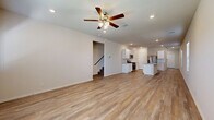 Located in the Yukon Crystal community of San Antonio, TX, this two-story home offers four bedrooms and four bathrooms across a well-designed layout. The main floor hosts the majority of the living space, featuring an open-concept living and dining area with light wood-look flooring, recessed lighting, and a ceiling fan. The kitchen is a standout, equipped with white shaker cabinets, a subway tile backsplash, granite countertops, a large center island with a sink, and stainless steel appliances. A dedicated pantry provides additional storage. A half bathroom with a pedestal sink is conveniently located on the main floor, along with a laundry room fitted with a full-size washer and dryer. The attached garage offers generous space with a concrete floor and automatic opener. Upstairs, the four bedrooms include a spacious primary suite with a walk-in closet and private bathroom. Additional closets throughout the home total six, ensuring ample storage. Light-toned wood flooring and neutral walls carry through the hallways and bedrooms, creating a bright, cohesive feel. The backyard is fully fenced with a grassy lawn and young trees, offering outdoor space with privacy.