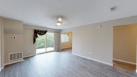 Located at 2601 Carpenter Station Rd in Wilmington, Delaware, this single-floor residence offers a well-planned layout designed for comfortable everyday living. The open living and dining area serves as the heart of the home, featuring light gray wood-look flooring, neutral toned walls, and a ceiling fan overhead. A sliding glass door leads to a private balcony overlooking lush greenery, filling the space with natural light and providing a pleasant outdoor connection.

The kitchen is a standout feature, finished with two-tone cabinetry—crisp white upper cabinets paired with deep navy blue lower cabinets—complemented by marble-look countertops and a full suite of stainless steel appliances, including a range, dishwasher, refrigerator, and a wall-mounted ventilation hood.

The bedrooms are carpeted for comfort, each offering neutral walls and natural light from windows. One bedroom includes a double sliding-door closet, providing ample storage. Additional carpeted rooms offer flexibility for various uses.

The bathroom features a tiled tub-and-shower combination with chrome fixtures and clean white finishes. A hallway bathroom vanity with wood-look flooring adds a polished touch. Overall, the space presents a clean, move-in-ready aesthetic throughout.