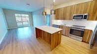 This contemporary apartment in Berwyn, PA, offers 900 square feet of thoughtfully designed living space. The open-plan layout seamlessly integrates the kitchen, living, and dining areas, creating a spacious feel. The kitchen is a highlight, boasting wooden cabinetry, stainless steel appliances, and a central island with pendant lighting.

The apartment features two bedrooms, including a primary bedroom of 150 square feet, each with plush carpeting and ample closet space. Two full bathrooms provide comfort and convenience, with one showcasing a modern tub-shower combination with sleek white tiling.

Throughout the apartment, large windows allow natural light to flood in, enhancing the airy atmosphere. The flooring alternates between warm hardwood in the main living areas and soft carpeting in the bedrooms, adding texture and comfort.

Storage is abundant, with walk-in closets in the bedrooms and additional storage solutions throughout. The unit also includes in-unit laundry facilities for added convenience.

Located at 400 W. Swedesford Road in Berwyn, this apartment combines modern aesthetics with practical living, making it an ideal home for those seeking contemporary comfort in a prime location.