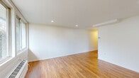 Located at 202 Vermont View Dr in Watervliet, NY, this single-floor, one-bedroom, one-bathroom unit offers a thoughtfully arranged layout that makes efficient use of its compact footprint. Warm honey-toned hardwood flooring runs throughout the main living areas and bedroom, lending a cohesive and inviting feel to the space.

The open living area is bright and clean, featuring recessed lighting set into white ceilings and crisp white walls that enhance the sense of openness. Hallways connect the main living space to the private areas, providing a logical flow through the unit.

The kitchen stands out as a well-appointed space, showcasing gray shaker-style cabinetry paired with speckled granite countertops and a classic white subway tile backsplash. A stainless steel sink is positioned beneath a window that brings in natural light and outdoor views, while light tile flooring completes the polished look.

The bedroom offers a comfortable footprint with a window providing natural light and a baseboard heating unit. Recessed lighting and clean white walls maintain the unit's consistent, modern aesthetic.

The bathroom features large-format stone-look tile on both the floors and tub surround, a soaking tub with a shower, and a white vanity, creating a calm and tidy space. Overall, the unit presents a clean, updated atmosphere throughout.
