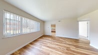 Located at 3205 Cross Keys Dr in Florissant, Missouri, this single-floor unit offers a clean, straightforward layout designed for comfortable everyday living. Throughout the main living and common areas, light-toned hardwood-style flooring creates a bright, cohesive look that ties the spaces together seamlessly.

The living area is generously sized, filled with natural light through large windows fitted with vertical blinds, and opens directly into the kitchen — making it an ideal space for both relaxing and entertaining. The kitchen is efficiently arranged, featuring light wood cabinetry with decorative trim, a white electric range, a single-basin sink, neutral countertops, and a classic tile backsplash that adds subtle texture to the space.

An additional room accessible from the main living area provides flexible space with the same hardwood-style flooring and access to natural light through a window. The bedroom offers plush carpeting underfoot, a sliding-door closet for storage, and a window that brings in ample natural light. The bathroom is tiled throughout, featuring a bathtub with a glass sliding shower enclosure and tile surround, maintaining a neutral and clean aesthetic. The unit's entry features a solid dark front door framed by a window, welcoming natural light into the space from the moment you step inside.