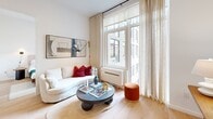 Located on Atlantic Avenue in Brooklyn, NY, this thoughtfully designed two-bedroom, two-bathroom residence offers a clean, modern aesthetic across a single floor. Light hardwood flooring runs throughout, complementing the crisp white walls and creating a bright, cohesive atmosphere.

The living room is anchored by large windows framed with sheer linen curtains, flooding the space with natural light and offering open urban views of the Brooklyn skyline. The kitchen features light wood cabinetry, white countertops, stainless steel appliances, and recessed lighting, alongside a wood dining table with bar seating — ideal for casual meals.

Both bedrooms are well-appointed with large windows that invite natural light and overlook the surrounding cityscape. The primary bedroom includes a built-in closet and warm, neutral tones throughout. The second bedroom mirrors the same understated elegance with ample storage.

The two bathrooms are finished with neutral stone-toned tiles. One bathroom features a full soaking tub with large-format marble-style wall tiles, while the second offers a sleek, minimalist design with a backlit oval mirror, wood vanity, and polished marble-look flooring — adding a refined, contemporary touch to the overall space.