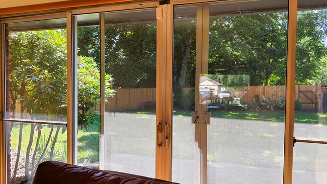 Living room looks out to the lush green backyard - 3645 SW 108th Ave