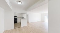Located at 3501 Jackson Ave in Hollywood, FL, this well-appointed 2-bedroom, 2-bathroom unit offers a bright and clean aesthetic throughout its single-floor layout. Light wood flooring runs continuously across every room, creating a cohesive and airy feel. The open-concept living and kitchen area serves as the heart of the home, with the kitchen featuring crisp white cabinetry, marble-style countertops and backsplash, black appliances including a range and refrigerator, and a stainless steel sink and dishwasher. A peninsula provides additional counter space and separates the kitchen from the expansive living area, which is bathed in natural light and opens to a private balcony through sliding glass doors, offering pleasant outdoor views. The spacious primary bedroom includes a dedicated closet and ample room for furnishings. The second bedroom also benefits from natural light via a large window with vertical blinds. Three closets in total provide generous storage throughout the unit. Both bathrooms are finished in white with light wood flooring — one features a walk-in shower, and the other a full bathtub. A connecting hallway ties all rooms together in a practical and functional layout.