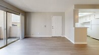 Located on Gadsden Ave in Lancaster, CA, this single-story 1-bedroom, 1-bathroom unit offers a clean, neutral aesthetic throughout. Light-toned luxury vinyl plank flooring runs continuously through the living spaces, complemented by soft warm-gray walls and crisp white trim, creating a bright and cohesive interior.

The combined kitchen and living area forms the heart of the unit. The galley-style kitchen is efficiently laid out with white cabinetry, speckled stone-look countertops, a white gas range, a full-size refrigerator, and a dishwasher. A window above the sink allows natural light to fill the space. The adjacent living room is open and airy, featuring a textured ceiling, a ceiling fan with light fixture, and a six-panel front entry door.

A hallway connects the main living area to the private spaces. The bedroom is a comfortable size, featuring a sliding-door closet, a textured ceiling, and a window with vertical blinds that admits natural light. The full bathroom includes a vanity with a speckled countertop, a toilet, and a tub/shower combination unit with a curved curtain rod. LVP flooring continues into the bathroom for a consistent finish.

The unit's clean, move-in-ready condition, neutral palette, and practical layout make it a functional and well-maintained living space in Lancaster's Antelope Valley area.
