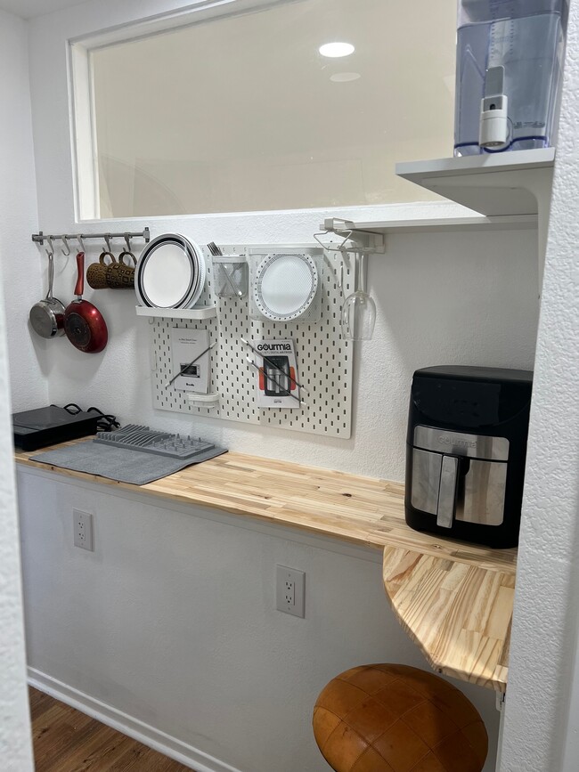 Kitchenette showing plates pots pans cutlery - 2236 River Run Dr