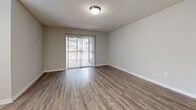 Located at Arbors Harbor Town in Memphis, Tennessee, this single-story residence offers a well-organized layout with a neutral color palette and a mix of wood-style and carpeted flooring throughout. The open living area features durable wood-style plank flooring and a sliding glass door that leads to a private balcony, allowing natural light to fill the space. An adjacent dining area benefits from a bank of tall windows fitted with blinds, further enhancing the brightness of the home.

The galley-style kitchen is outfitted with white cabinetry, granite-style countertops, a subway tile backsplash, stainless steel appliances, and a sink with ample workspace on either side. Light wood-style flooring carries through this area, maintaining visual continuity.

The bedrooms are carpeted and generously sized, each featuring textured ceilings and large windows that allow natural light to enter. The bathroom includes a granite-style vanity with a large mirror, wood-style flooring, and a tub-shower combination. Throughout the residence, clean white trim, neutral wall tones, and textured ceilings contribute to a cohesive and functional living environment.