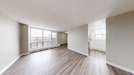 Located at 280 Wentworth Street in Oshawa, Ontario, this 2-bedroom, 1-bathroom unit offers a well-organized layout across a single floor. The open-concept living and dining area is a standout feature, bathed in natural light through large floor-to-ceiling windows that lead out to a private balcony overlooking the surrounding neighbourhood. Consistent light-toned laminate flooring flows throughout the unit, complemented by neutral warm-grey walls and white baseboards that give the space a clean, modern aesthetic. The renovated kitchen is thoughtfully designed with white shaker-style cabinetry, brushed gold and silver hardware, marble-effect countertops, a subway tile backsplash, a stainless steel refrigerator, and an electric range. Both bedrooms are comfortably sized, each featuring laminate flooring, natural light, and sliding-door closets for convenient storage. The primary bedroom offers a generous footprint and ample closet space. A dedicated closet provides additional storage within the unit. Baseboard heating is present throughout, and textured ceilings add a classic finishing touch. This unit presents a functional and refreshed living space in a well-established Oshawa community.