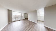 Located at 280 Wentworth Street in Oshawa, Ontario, this 2-bedroom, 1-bathroom unit offers a well-organized layout across a single floor. The open-concept living and dining area is a standout feature, bathed in natural light through large floor-to-ceiling windows that lead out to a private balcony overlooking the surrounding neighbourhood. Consistent light-toned laminate flooring flows throughout the unit, complemented by neutral warm-grey walls and white baseboards that give the space a clean, modern aesthetic. The renovated kitchen is thoughtfully designed with white shaker-style cabinetry, brushed gold and silver hardware, marble-effect countertops, a subway tile backsplash, a stainless steel refrigerator, and an electric range. Both bedrooms are comfortably sized, each featuring laminate flooring, natural light, and sliding-door closets for convenient storage. The primary bedroom offers a generous footprint and ample closet space. A dedicated closet provides additional storage within the unit. Baseboard heating is present throughout, and textured ceilings add a classic finishing touch. This unit presents a functional and refreshed living space in a well-established Oshawa community.