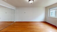 Located at 419 Erie St SE in Minneapolis, MN, this one-bedroom, one-bathroom unit offers an efficient and well-organized layout across a single floor. The living area features warm-toned hardwood flooring that reflects natural light from a large window fitted with blinds, creating a bright and inviting atmosphere. A wall-mounted air conditioning unit and baseboard heating ensure year-round comfort. The kitchen, visible in the floor plan overview, is compactly designed with wood-toned cabinetry, counter space, and room for essential appliances including a refrigerator, making practical use of every square foot. The bedroom is carpeted for added comfort and warmth, featuring two windows that bring in ample daylight, a mirrored sliding-door closet, and baseboard heating. The neutral, beige-toned walls throughout the unit lend a clean, understated aesthetic. The bathroom includes a full soaking tub with tile surround in warm earth tones, complemented by built-in corner shelving for storage. Classic flush-mount light fixtures with decorative details add a subtle vintage charm to the space. Overall, this unit presents a straightforward, functional living environment suited for individuals seeking a cozy, manageable home in Minneapolis.