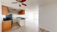 Located on the third floor at 464 S Berendo St in the Koreatown neighborhood of Los Angeles, this one-bedroom, one-bathroom unit offers a well-organized and functional layout across a single floor. The open-concept living and dining area flows seamlessly from the kitchen, creating a bright, airy feel enhanced by light wood laminate flooring and white walls throughout. A ceiling fan with overhead lighting serves the combined living space, while large windows dressed with vertical blinds allow generous natural light to fill the room. The kitchen features warm wood cabinetry, granite-style countertops, a double basin sink, tile flooring, and stainless steel appliances including a range and refrigerator, along with a convenient peninsula that opens to the living area. The spacious bedroom includes dual mirrored sliding closet doors that amplify light and space, with an additional window providing natural ventilation. Three closets in total offer excellent storage throughout the unit. The full bathroom is finished with tile flooring, a combined tub and shower with sliding glass doors, a pedestal-style vanity, and brushed nickel fixtures. A hallway connects the main living spaces, completing this efficient and comfortable floor plan.