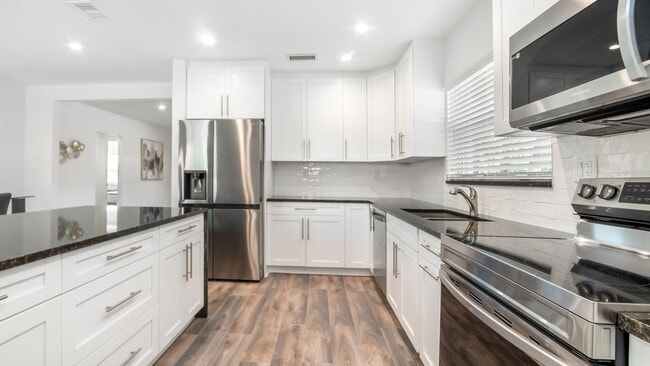 Kitchen facing south. - 121 George Bush Blvd