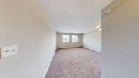 Located at 810 Lasalle Ave in Hampton, Virginia, this single-floor home presents a clean, modern aesthetic with thoughtful updates throughout. Light wood-look flooring runs consistently across the living spaces, complementing the neutral warm-gray wall tones and bright white trim that create a cohesive, airy feel.

The kitchen is a standout feature, outfitted with crisp white shaker-style cabinetry, light quartz countertops, and a full suite of stainless steel appliances including an electric range, over-the-range microwave, dishwasher, and refrigerator. A double-basin stainless steel sink with a modern pull-down faucet anchors the workspace.

The bedrooms are generously proportioned, each benefiting from natural light through horizontal-blind-fitted windows that offer views of the surrounding neighborhood. One bedroom includes a built-in closet with ample storage space. The textured ceilings add subtle architectural character to the rooms.

The bathroom is neatly appointed with a full tub-shower combo, white vanity, and chrome fixtures, all finished with matching light hardwood flooring for a consistent look. The overall layout, as visible in the overhead dollhouse view, flows efficiently between the living, kitchen, bedroom, and bathroom areas, making this a well-organized and move-in-ready home.