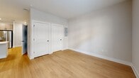 Located at 1155 Lavista Rd NE in Atlanta's vibrant 30324 corridor, this thoughtfully designed single-floor unit delivers a modern aesthetic with efficient, well-appointed spaces. The open-concept kitchen and living area serves as the heart of the unit, where light wood-tone cabinetry with matte black hardware pairs with a white subway tile backsplash and crisp white countertops. A full suite of stainless steel appliances — including a gas range, built-in microwave, dishwasher, and French door refrigerator — completes the kitchen. A peninsula with an undermount sink and stylish pendant lighting above adds a functional and visual focal point. The living area benefits from light-toned luxury vinyl plank flooring that extends throughout the unit, neutral wall tones, and a set of French doors topped with transom windows that invite natural light and offer outdoor views. A ceiling fan provides additional comfort. The bathroom is finished with a wood-toned vanity, white countertop, a large framed mirror, and contemporary matte black fixtures and lighting. Two closets provide ample storage, and a dedicated utility room adds practical convenience. Clean lines, consistent finishes, and a bright, neutral palette give this unit a cohesive, modern feel.