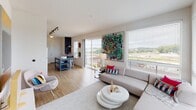 Located at 434 E 36th St in Charlotte, NC, this single-floor residence showcases a contemporary design with light wood flooring, neutral tones, and an abundance of natural light throughout. The open-concept living area is anchored by floor-to-ceiling sliding glass doors that lead to a private balcony, offering sweeping outdoor views of the surrounding landscape. Multiple large windows fitted with white shutters further brighten the space, creating an airy, welcoming ambiance.

The kitchen is well-equipped with stainless steel appliances, including a refrigerator, electric range, microwave, and dishwasher. Granite countertops, dark wood cabinetry, and high-gloss white upper cabinets provide a sharp contrast, while track lighting overhead adds functional illumination. A movable island with a dark top and blue base offers additional prep and casual dining space.

The bedroom is a calm retreat featuring a ceiling fan, plantation-shuttered windows, and a distinctive sliding barn door that opens to a walk-in closet area with open shelving and organized storage. The bathroom continues the unit's design language with granite counters and dark cabinetry. Throughout, light wood flooring ties the space together with a clean, modern aesthetic.