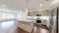 Located in Frisco, TX, this thoughtfully designed three-story home offers four bedrooms and four bathrooms across a generous, well-appointed layout. The ground floor includes a garage and utility spaces, while the main living level features an open-concept dining, kitchen, and living area filled with natural light. The kitchen is a standout, showcasing light wood cabinetry, granite countertops, a center island with pendant lighting, stainless steel appliances, and rich hardwood flooring that flows seamlessly into the living area, which is equipped with a ceiling fan and recessed lighting. Upper floors house the bedrooms, a loft, and a dedicated laundry room. Bedrooms feature plush carpeting, large windows with exterior views, and access to well-organized closets with built-in shelving. The bathrooms are finished with tile flooring, granite vanities, and glass-enclosed walk-in showers with elegantly tiled surrounds. Hallways are bright and clean with recessed lighting and the same hardwood flooring found throughout the main living areas. Six closets and ample storage ensure functionality throughout. The overall aesthetic is modern and neutral, with crisp white walls, taupe doors, and consistent finishes creating a cohesive, move-in-ready environment.