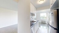 Located at 286 Finch Ave W, Unit 403 in North York, Toronto, this 2-bedroom, 1-bathroom residence offers a well-organized layout across a single floor. Polished parquet flooring runs throughout the unit, adding warmth and a classic character to every room.

The living room is a generously sized, open area bathed in natural light, with clean white walls and seamless access to the rest of the unit. A balcony off the living area provides outdoor views of the surrounding residential neighbourhood, framed by mature trees and open sky.

Both bedrooms are well-proportioned and feature large windows that invite abundant natural light. The primary bedroom is a comfortable size, complete with closet space and a classic radiator heating unit. The second bedroom mirrors this design, offering similar light and storage.

The bathroom is finished with white subway tile surrounding a full bathtub and shower combination, complemented by stone-tiled flooring, a vanity, and a small window for ventilation. The overall aesthetic is clean and functional.

Two hallways connect the rooms efficiently, and the layout flows logically throughout. Radiator heating is present in multiple rooms, ensuring consistent warmth. The unit presents a bright, functional living space in a well-established Toronto neighbourhood.