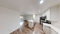 Located at 4424 44th St in San Diego, California, this single-floor residence offers a clean, modern aesthetic with thoughtful design throughout. The open-concept layout seamlessly connects the kitchen and living area, creating a bright and functional space ideal for everyday living.

The kitchen is a standout feature, equipped with stainless steel appliances including a refrigerator, range, and over-the-range microwave. White shaker-style cabinetry extends to the ceiling for ample storage, while marble-look quartz countertops add a refined touch. A center island with a built-in sink and additional cabinetry provides extra prep space and serves as a natural gathering point.

Wood-style plank flooring flows throughout the main living areas, complementing the crisp white walls and recessed lighting that keep the space feeling open and airy. The living area features a sliding glass door fitted with vertical blinds, offering direct access to a private outdoor patio and allowing natural light to fill the room.

The bedroom is finished with plush carpeting and includes a mirrored sliding-door closet, providing practical storage while enhancing the sense of space. An adjoining bathroom is accessible directly from the bedroom, completing the private quarters. The overall design is clean, contemporary, and move-in ready.