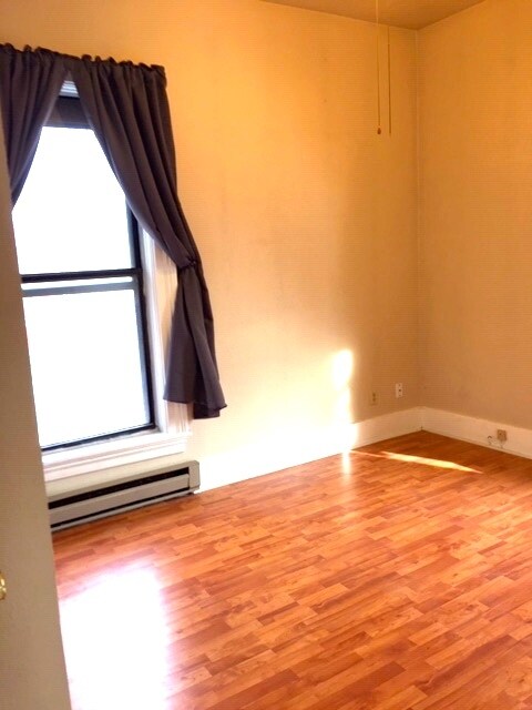 Bedroom 1, north and east facing windows, closet with significant storage space above. - 425 E Broadway St