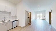 Located at 7207 McKnight Rd in Pittsburgh's 15237 zip code, this well-appointed 2-bedroom, 2-bathroom residence offers a thoughtfully designed single-level layout with modern finishes throughout. The open-concept living and dining area features light wood-tone luxury vinyl flooring, recessed lighting, and a sliding glass door that opens to a private balcony with scenic outdoor views — filling the space with natural light.

The kitchen is equipped with stainless steel appliances including a refrigerator, range, microwave, and dishwasher. Crisp white subway tile backsplash, white quartz-style countertops, and two-tone cabinetry in white and gray complete the contemporary aesthetic. A convenient in-unit stacked washer and dryer closet is located just off the main living area.

Both bedrooms are carpeted and bathed in natural light through large windows overlooking the surrounding greenery and Pittsburgh skyline. The primary bedroom includes a spacious walk-in closet with wire shelving. Each bathroom is finished in a clean, modern style — one featuring a frameless sliding glass walk-in shower with white tile surround, a floating vanity, and wood-tone flooring. The overall ambiance is bright, clean, and move-in ready.