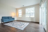 Located at 711 Myrtle Way in Janesville, Wisconsin, this well-appointed 2-bedroom, 2-bathroom single-floor residence offers a thoughtfully designed layout with modern finishes throughout. The open-concept kitchen and living area serves as the heart of the home, featuring rich dark-stained cabinetry, a full suite of stainless steel appliances, and a generous island with a light stone countertop and pendant lighting above — ideal for both casual dining and entertaining. The living area is bathed in natural light from large windows that frame views of the surrounding greenery.

A welcoming entrance leads down a clean, hardwood-floored hallway connecting all areas of the home. The primary bedroom offers a comfortable, carpeted retreat with ample natural light. The second bedroom, also carpeted, includes a window with outdoor views and a ceiling fan. Three closets provide generous storage throughout.

Both bathrooms are finished with tile flooring and dark wood vanities. The primary bath features a wide vanity with a white countertop and well-lit mirror, while the second bath includes accessibility-friendly grab bars. A dedicated laundry area adds everyday convenience. Outdoor views include open green space and the surrounding residential community.