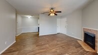 Located at 806 Galaxy Dr in Jackson, Tennessee, this single-floor home offers a well-designed layout with a variety of functional and comfortable spaces throughout. The living room serves as a welcoming centerpiece, featuring wood-look flooring, a ceiling fan with light fixture, a textured ceiling, and a tiled fireplace — all framed by multiple windows that invite natural light into the room. Adjacent to the living area, the galley-style kitchen is efficiently arranged with grey cabinetry, marble-look countertops, a stainless steel sink, and black appliances including a refrigerator, electric range, microwave, and dishwasher, complemented by wood-look flooring and white upper cabinets for ample storage. The dining and entry areas continue the open, airy feel with matching flooring and a ceiling fan overhead. The bedrooms are carpeted and generously sized, each equipped with ceiling fans and windows offering natural views. The primary bedroom connects to a private en-suite bath and features a walk-in closet. The bathrooms include tiled flooring, a vanity with marble-look countertops, a white framed mirror, and a shower-tub combination. A dedicated laundry room accommodates a full-size washer and dryer with overhead shelving and wood-look flooring, adding everyday convenience to this well-appointed home.