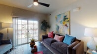 This single-floor residence offers a thoughtfully designed layout that balances modern finishes with a warm, livable atmosphere. The open-concept living area serves as the heart of the home, featuring wood-look flooring, a ceiling fan, and a sliding glass door that opens to a private balcony — flooding the space with natural light and offering outdoor views. The kitchen is a standout feature, showcasing dark espresso cabinetry that extends to the ceiling, stainless steel appliances, a subway tile backsplash, granite countertops, and a peninsula with bar seating illuminated by a stylish pendant light. The kitchen and dining area flow seamlessly together, creating an ideal space for both everyday living and entertaining. The bedroom is a comfortable retreat, finished with plush carpeting, a window with ample natural light, and a tray ceiling detail that adds architectural character. The en-suite bathroom is well-appointed with granite countertops, dark wood vanity cabinetry, a walk-in shower, and direct access to a spacious walk-in closet complete with built-in shelving and hanging storage. Throughout the residence, neutral tones and clean lines create a cohesive and inviting ambiance.