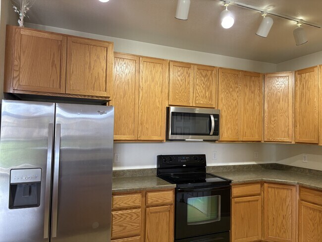Kitchen with all necessary appliances and cabinet space - 3875 S Dayton St