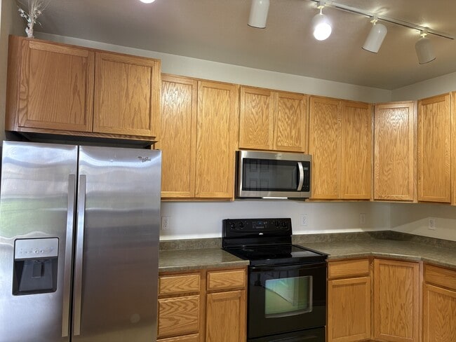 Kitchen with all necessary appliances and cabinet space - 3875 S Dayton St